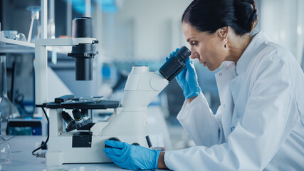 Medical Development Laboratory: Portrait of Beautiful Caucasian Female Scientist Looking Under...