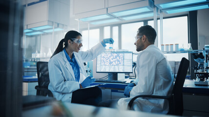 Modern Medical Research Laboratory: Portrait of Two Scientists Working, Using Digital Tablet, Analyzing Samples, Talking. Advanced Scientific Pharmaceutical Lab for Medicine, Biotechnology Development