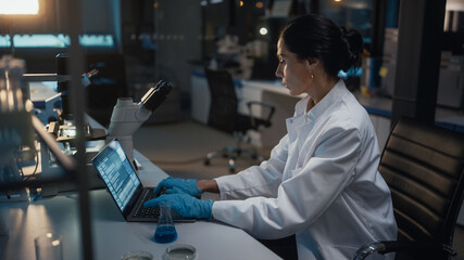Medical Development Laboratory: Female Scientist Works on Laptop, Enters Data for Further Analysis....
