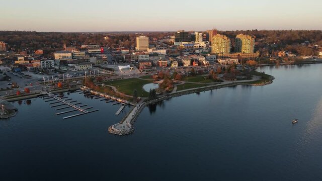 City of Barrie waterfront and downtown aerial drone dolly shot with Lake Simcoe marina, condo buildings, banks, parks and infrastructure. Clear fall day.