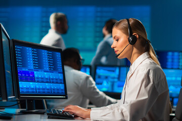 Diverse team of brokers workin in office using workstation and analysis technology. Workplace of professional traders. Global financial markets, business strategy, currency exchange and banking.