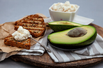 Sandwiches with soft cheese, avocado and cucumber. Breakfast is on the table. Healthy food. Toast and spread on it. Avocado sandwich stilllife. Healthy food. Toast.