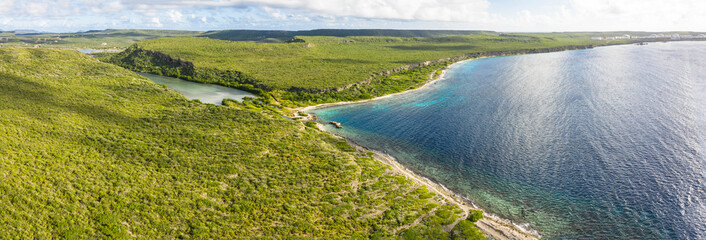 Aerial view above scenery of Curacao, Caribbean with ocean, coast, hills 
