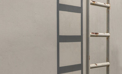 White metal fire escape attached to a wall and leading to the roof of a building. Copy space, No...