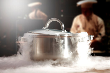 A pot in the kitchen with lots of steam