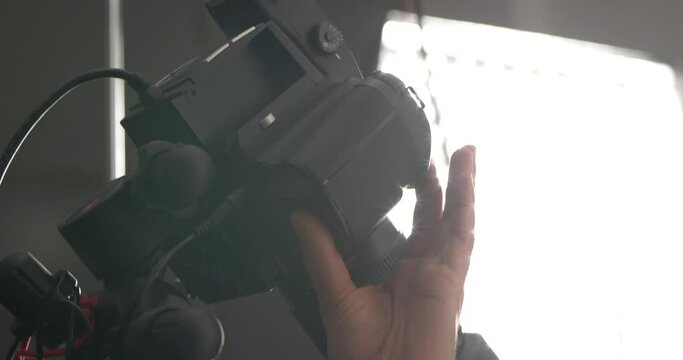 Camera button being pressed at a photoshoot