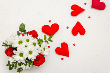 A bouquet of fresh flowers and red felt hearts for Valentine's day or Wedding