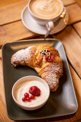 breakfast with chocolate raspberry and currant croissant and italian cappuccino