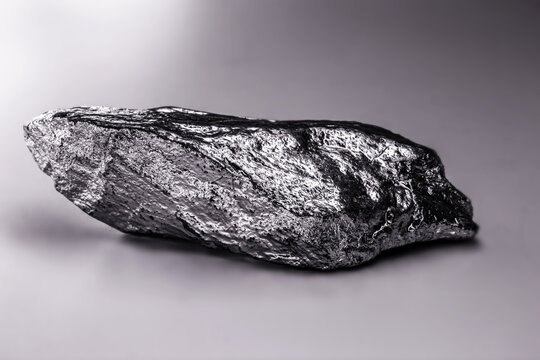 Raw manganese. Manganese stone isolated on white background. Mineral extraction of heavy metals.