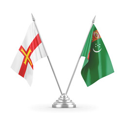 Turkmenistan and Guernsey table flags isolated on white 3D rendering