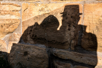 Shadows of a pair of lovers on the big rocks of a medieval castle