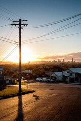 View of a street on the outskirts of Brisbane at sunset, Queensland, Australia. - obrazy, fototapety, plakaty