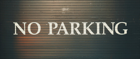 no parking sign painted on a garage door.