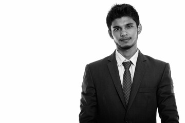 Studio shot of young handsome Indian businessman