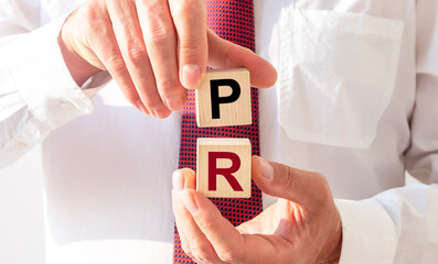 PR acronym word on cubes. Public Relations concept