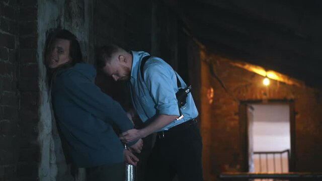 Police officer catching and arresting young man drug trafficker