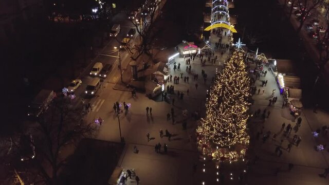 Christmas tree, Fair market, aerial view in city center at winter night. Happy New Year 2021 in Lviv, Ukraine December 2020 oposite Opera house. Festive lights on. Santa Claus celebration holidays