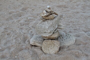 Stones stacked on sand