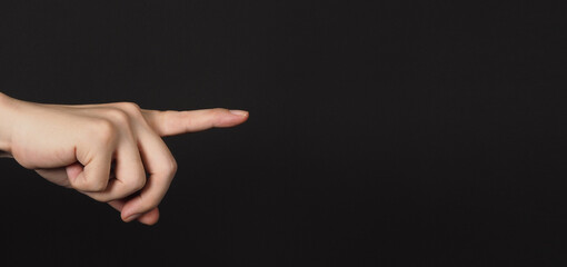 Index finger pointing to something, isolated on black background.