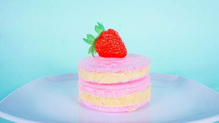 Rambut Nenek or Arumanis (Cotton Candy with Crackers) served on white plate. one of sweet snack food from Indonesia