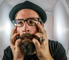 A bearded and desperately looking man with empty eyes