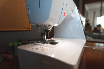 Hands working on a sewing machine