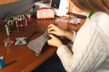 Young dressmaker working on the studio with textiles