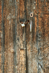 Old wooden door with chain and security lock