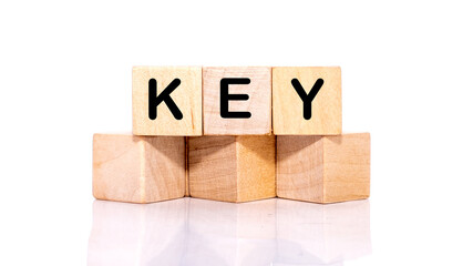 KEY Word written on wooden blocks on a white background.