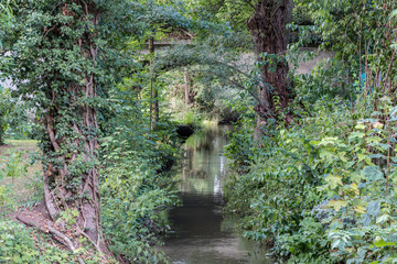 Little bridge across the little creek in the green countryside
