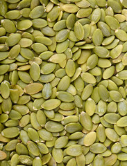 Pumpkin seeds background, top view