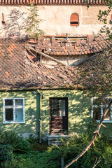 Broken roof of an old house near the city wall