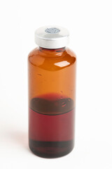 Macro Image Of Amber Vaccine Vial In White Background