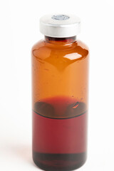 Macro Image Of Amber Vaccine Vial In White Background