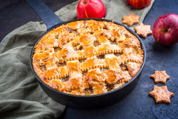 Modern style traditional apple jalousie cake served as close-up in a design backing form at a black board