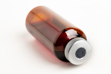 Macro Image Of Amber Vaccine Vial In White Background