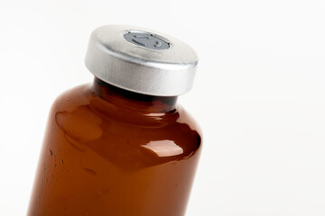 Macro Image Of Amber Vaccine Vial In White Background