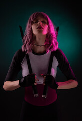 Sexy female assassin with pink hair wearing black holding swords