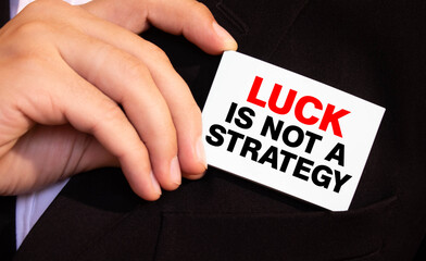 LUCK IS NOT A STRATEGY, message on the card shown by a man