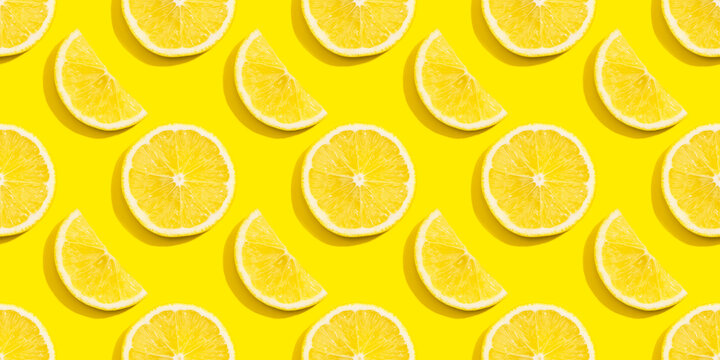 Seamless pattern of lemon slices on a yellow background.