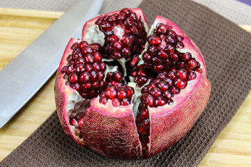Close up of a pomegranate seed that is open. Large red pomegranate seeds. Fruit pomegranate.