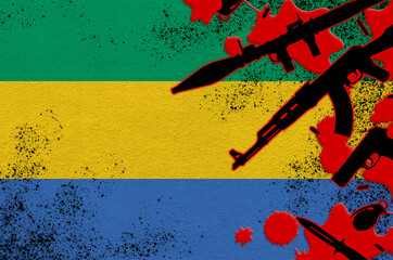 Gabon flag and various weapons in red blood. Concept for terror attack or military operations with...