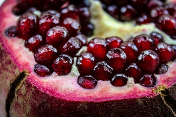 Close up of pomegranate seed. Open pomegranate fruit where ripe red pomegranate seeds are seen. Fruit pomegranate. Macro.