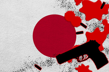 Japan flag and black firearm in red blood. Concept for terror attack or military operations with...