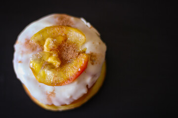 Delicious Donuts with apple and cinnamon on a black background