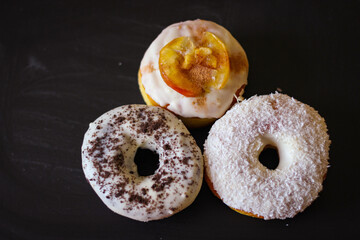 Three delicious Donuts on a black background