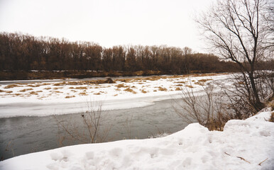 Winter forest, frozen empty trees, frosty morning, river flow