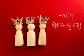Three wise men figures with crowns on red background and the text Happy Epiphany day.