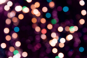 Christmas glowing garland with defocused multicolored lights. Colorful holiday background. Happy new year background.
