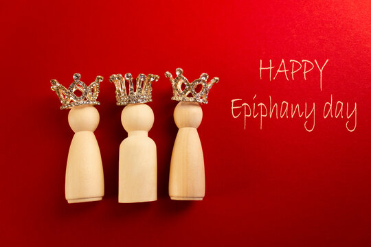 Three wise men figures with crowns on red background and the text Happy Epiphany day.